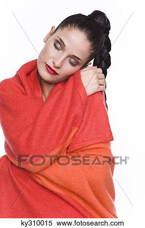 Stock Photography - Young woman wrapped in blanket. Fotosearch