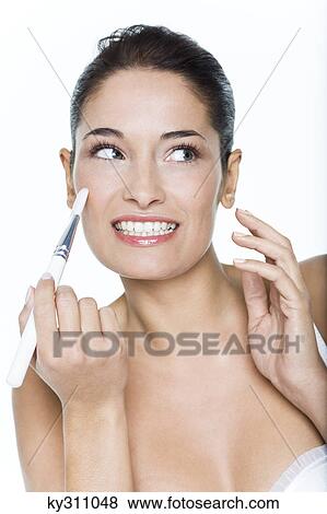 Young woman applying blush View Large Photo Image Stock Photo - Young woman applying blush. Fotosearch