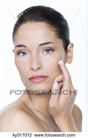 Young woman applying moisturizer View Large Photo Image Stock Image - Young woman applying moisturizer. Fotosearch