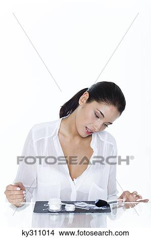 Young woman looking at cosmetics display View Large Photo Image Picture - Young woman looking at cosmetics display. Fotosearch