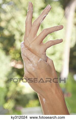 Close-up of woman's hands applying moisturizer View Large Photo Image Picture - Close-up of woman's hands applying moisturizer. Fotosearch