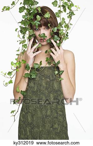 Stock Photo - Woman with ivy covering her face. Fotosearch
