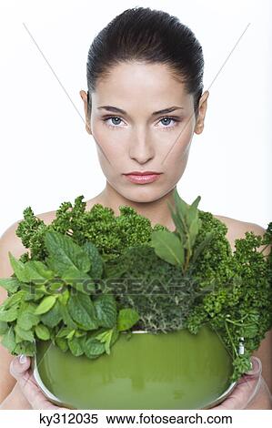 Young woman holding fresh herbs View Large Photo Image Stock Photography - Young woman holding fresh herbs. Fotosearch