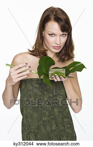 Picture - Young woman holding olive oil soap. Fotosearch
