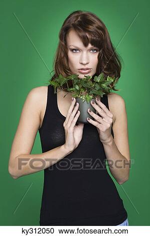 Young woman holding pot of ivy View Large Photo Image Stock Image - Young woman holding pot of ivy. Fotosearch