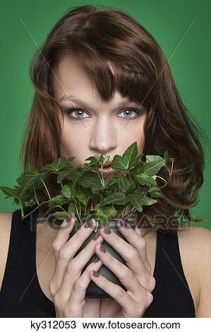 Young woman holding pot of ivy View Large Photo Image Stock Image - Young woman holding pot of ivy. Fotosearch