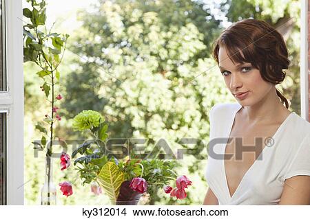 Picture - Young woman looking at camera. Fotosearch