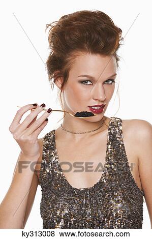 Young woman eating caviar View Large Photo Image Stock Photo - Young woman eating caviar. Fotosearch