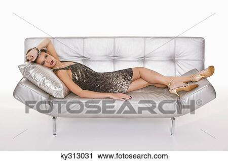 Young woman in formalwear resting on sofa View Large Photo Image Stock Image - Young woman in formalwear resting on sofa. Fotosearch