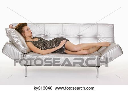 Young woman in formalwear resting on sofa View Large Photo Image Stock Image - Young woman in formalwear resting on sofa. Fotosearch
