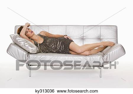 Young woman in formalwear sleeping on sofa View Large Photo Image Stock Photograph - Young woman in formalwear sleeping on sofa. Fotosearch