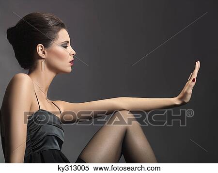 Young woman looking at fingernails View Large Photo Image Stock Photography - Young woman looking at fingernails. Fotosearch