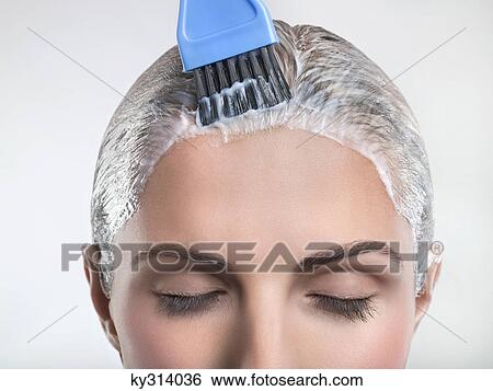 Young woman applying hair color View Large Photo Image Stock Photograph - Young woman applying hair color. Fotosearch