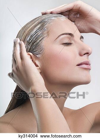 Young woman applying hair mask View Large Photo Image Picture - Young woman applying hair mask. Fotosearch