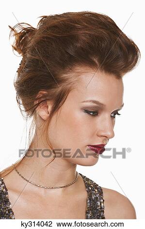 Stock Image - Young woman day dreaming. Fotosearch