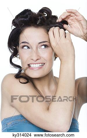 Young woman fixing hair clips View Large Photo Image Picture - Young woman fixing hair clips. Fotosearch