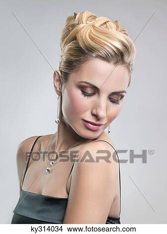 Young woman in formalwear with eyes closed View Large Photo Image Picture - Young woman in formalwear with eyes closed. Fotosearch