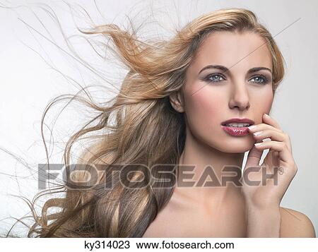 Stock Image - Young woman looking away. Fotosearch