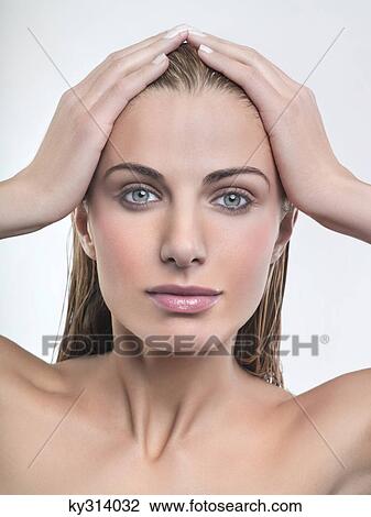 Young woman with hands in hair View Large Photo Image Stock Image - Young woman with hands in hair. Fotosearch