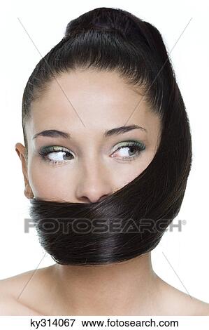 Young woman with long hair covering mouth View Large Photo Image Stock Photo - Young woman with long hair covering mouth. Fotosearch