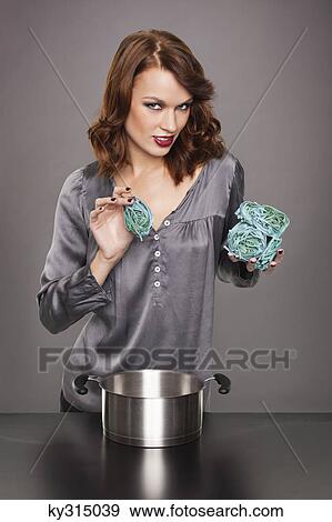 Young woman cooking seaweed pasta View Large Photo Image Stock Photo - Young woman cooking seaweed pasta. Fotosearch