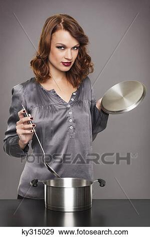 Young woman cooking View Large Photo Image Stock Photo - Young woman cooking. Fotosearch