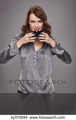 Picture - Young woman drinking coffee. Fotosearch