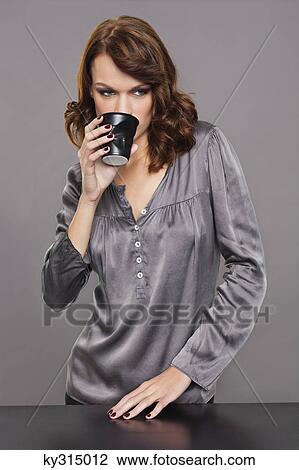 Young woman drinking coffee View Large Photo Image Stock Image - Young woman drinking coffee. Fotosearch