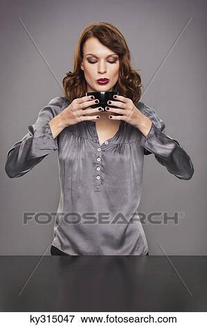 Stock Photo - Young woman drinking coffee. Fotosearch