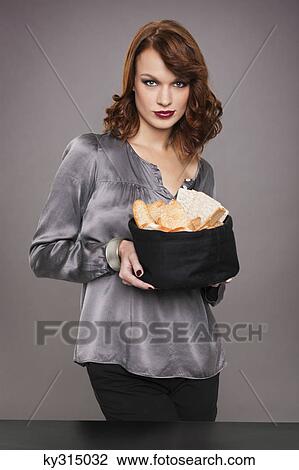 Young woman holding basket of breads View Large Photo Image Stock Image - Young woman holding basket of breads. Fotosearch