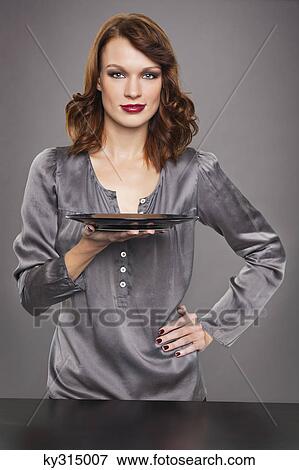 Young woman holding plate View Large Photo Image Stock Photo - Young woman holding plate. Fotosearch