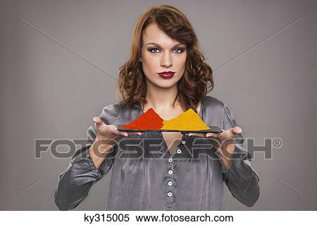 Young woman holding spices View Large Photo Image Stock Photography - Young woman holding spices. Fotosearch