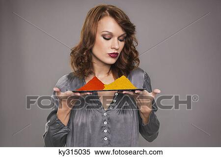 Stock Photography - Young woman holding spices. Fotosearch