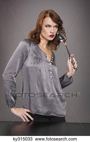 Young woman holding spoon View Large Photo Image Stock Image - Young woman holding spoon. Fotosearch