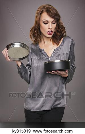 Stock Photo - Young woman opening box. Fotosearch