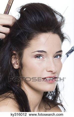 Stock Image - Young woman getting her hair done. Fotosearch