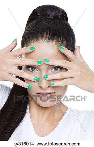 Young woman looking through fingers View Large Photo Image Picture - Young woman looking through fingers. Fotosearch