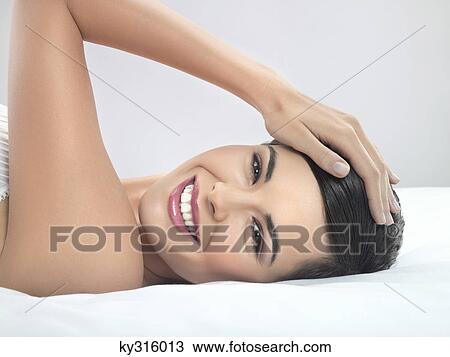Young woman lying on back View Large Photo Image Stock Image - Young woman lying on back. Fotosearch