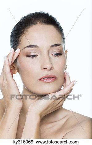 Young woman touching her face View Large Photo Image Stock Photography - Young woman touching her face. Fotosearch