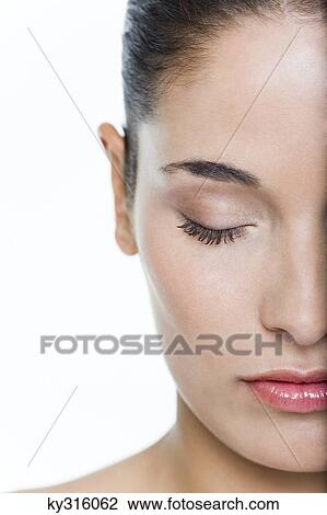 Stock Image - Young woman with eyes closed. Fotosearch