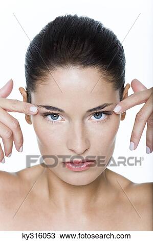 Young woman with fingers on temples View Large Photo Image Stock Image - Young woman with fingers on temples. Fotosearch