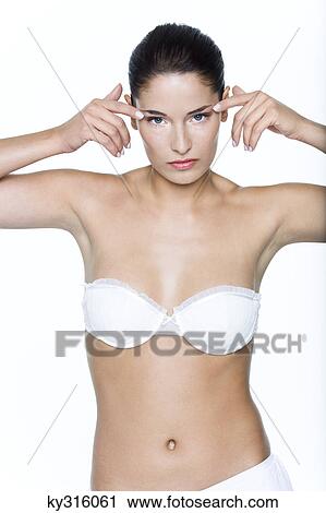Young woman with fingers on temples View Large Photo Image Stock Image - Young woman with fingers on temples. Fotosearch