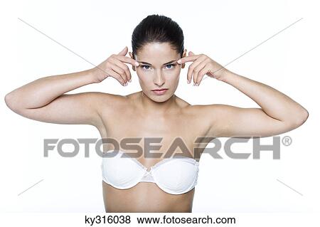 Stock Photo - Young woman with fingers on temples. Fotosearch