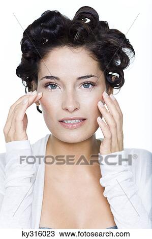 Young woman with hair clips View Large Photo Image Stock Image - Young woman with hair clips. Fotosearch