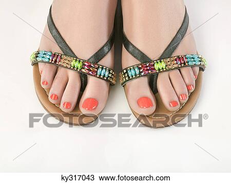 Close-up of woman's feet with sandals View Large Photo Image Stock Image - Close-up of woman's feet with sandals. Fotosearch