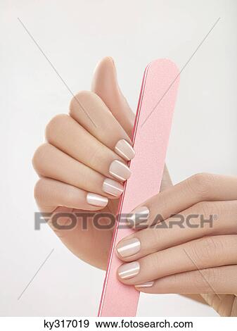 Stock Photo - Woman filing nails, close-up. Fotosearch
