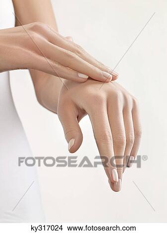 Picture - Woman massaging her hand, close-up. Fotosearch
