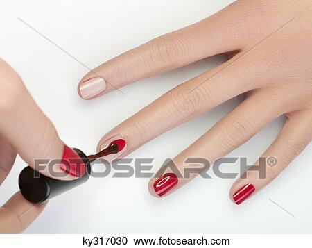Woman painting fingernails, close-up View Large Photo Image Stock Image - Woman painting fingernails, close-up. Fotosearch