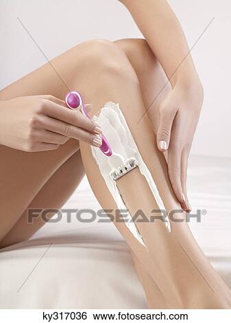 Woman shaving her leg View Large Photo Image Stock Photograph - Woman shaving her leg. Fotosearch