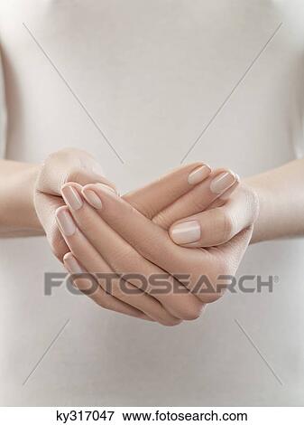 Stock Photo - Woman with hands cupped, close-up. Fotosearch